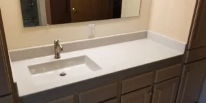 A bathroom sink and mirror in front of a mirror.