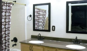 A bathroom with two sinks and mirrors in it