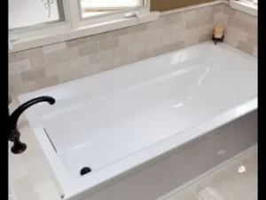 A bathtub with the lid up in a bathroom.